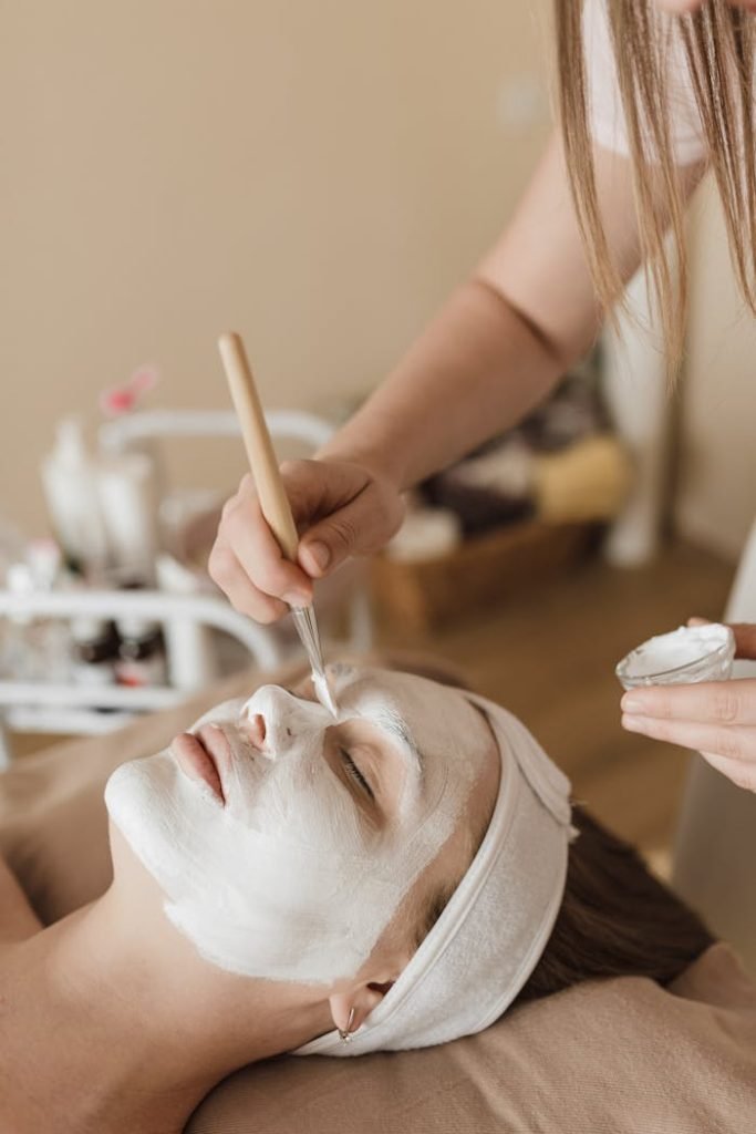 a-person-applying-facial-mask-on-a-womans-face-6663365 A soothing facial mask application during a spa treatment, promoting relaxation and skincare.